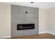 The contemporary electric fireplace features blue flame accents set against a sleek gray tiled wall at 356 Gulfport Ct, Las Vegas, NV 89145