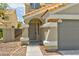 Close up view of the front of this home featuring a covered entryway and attached two-car garage at 356 Gulfport Ct, Las Vegas, NV 89145