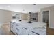 Open-concept kitchen with a large island, modern lighting, and easy access to the living room and bathroom at 356 Gulfport Ct, Las Vegas, NV 89145