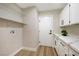 Functional laundry room with overhead shelving, counter space, and ample cabinet storage at 356 Gulfport Ct, Las Vegas, NV 89145