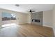 Bright living room with sliding glass door to backyard, electric fireplace, and wood-look tile floors at 356 Gulfport Ct, Las Vegas, NV 89145