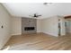 Cozy living room with sleek electric fireplace, ceiling fan, and wood-look tile floors at 356 Gulfport Ct, Las Vegas, NV 89145