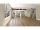 Open living space with wood-look tile floors and a modern light fixture, next to the kitchen at 356 Gulfport Ct, Las Vegas, NV 89145