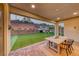 Covered patio overlooking a lush backyard with a playground and artificial turf at 365 Crown Mesa Ave, Las Vegas, NV 89138