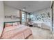 Charming bedroom with pink accents, floral wallpaper, and bright natural light for a cozy feel at 365 Crown Mesa Ave, Las Vegas, NV 89138