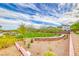 Well-maintained community green space featuring a lush lawn, stone accents, and young trees under a bright, clear sky at 365 Crown Mesa Ave, Las Vegas, NV 89138