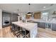 Open-concept kitchen boasts a large island, stainless steel appliances, custom cabinets, and backyard views from the window at 365 Crown Mesa Ave, Las Vegas, NV 89138