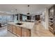 Gourmet kitchen boasts an island with pendant lighting, wood cabinets, and modern appliances at 365 Crown Mesa Ave, Las Vegas, NV 89138