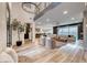 Open concept living room with hardwood floors and high ceilings is perfect for entertaining and features stylish modern decor at 365 Crown Mesa Ave, Las Vegas, NV 89138