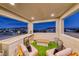 Stylish patio with comfortable seating, mini-fridge, and views of the city lights in the distance at 365 Crown Mesa Ave, Las Vegas, NV 89138
