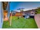 Backyard playground with swings, slide, and playhouses on artificial turf at 365 Crown Mesa Ave, Las Vegas, NV 89138