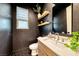 Chic powder room featuring dark walls, floating shelves, and sleek fixtures at 365 Crown Mesa Ave, Las Vegas, NV 89138
