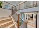 A modern staircase with wooden steps, a dark railing, and an open design that highlights the home's architecture at 365 Crown Mesa Ave, Las Vegas, NV 89138