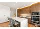 Modern kitchen features wood cabinetry, a center island with seating, and stainless steel appliances at 3750 Las Vegas Blvd # 3006, Las Vegas, NV 89158