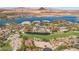 Panoramic aerial perspective of a golf course, lake, luxury homes, and mountainside desert landscape at 38 Grand Miramar Dr, Henderson, NV 89011