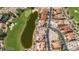 Stunning aerial view of luxurious homes adjacent to a golf course and pond, in a serene environment at 38 Grand Miramar Dr, Henderson, NV 89011