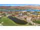 Expansive aerial view of luxury homes, a lake and a golf course nestled amidst desert mountains at 38 Grand Miramar Dr, Henderson, NV 89011