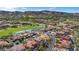 Scenic aerial view of a community, lush golf course, and desert landscape with distant mountains at 38 Grand Miramar Dr, Henderson, NV 89011