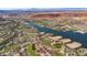 Sweeping aerial view showcasing luxury homes bordering a golf course and lake, with mountains in the distance at 38 Grand Miramar Dr, Henderson, NV 89011