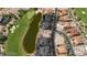 Expansive aerial view of luxury homes along a golf course with a serene pond, showcasing the community's beauty at 38 Grand Miramar Dr, Henderson, NV 89011