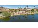 Beautiful waterfront houses with palm trees reflected in a serene, tree-lined lake at 38 Grand Miramar Dr, Henderson, NV 89011