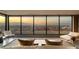 Panoramic city views from the bed of this modern main bedroom with lounge chairs at 4 Horseshoe Rock Ct, Henderson, NV 89012