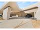 Expansive driveway leading to a modern home with covered parking and desert landscape at 4 Horseshoe Rock Ct, Henderson, NV 89012