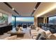 Open living space with modern furnishings, a bar area, and expansive windows showcasing city views at 4 Horseshoe Rock Ct, Henderson, NV 89012