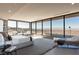 Bright main bedroom featuring floor to ceiling windows, city views, and lounge seating at 4 Horseshoe Rock Ct, Henderson, NV 89012