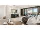 Bright main bedroom with seating area, and sliding doors leading to a balcony with city views at 4 Horseshoe Rock Ct, Henderson, NV 89012