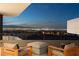 Relaxing outdoor patio with cushioned chairs overlooking the glittering city skyline at 4 Horseshoe Rock Ct, Henderson, NV 89012