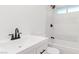 Bathroom with white tile, dark fixtures, and modern sink giving a clean and stylish space for daily routines at 4046 Bridgeview Cir, Las Vegas, NV 89147