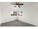This bright bedroom features a ceiling fan, neutral color scheme, and large windows at 4046 Bridgeview Cir, Las Vegas, NV 89147