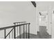 Bright hallway with neutral walls, metal railings, and access to additional rooms creating a clean and modern aesthetic at 4046 Bridgeview Cir, Las Vegas, NV 89147