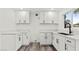 Contemporary kitchen with white cabinets, dark hardware and ample counter space at 4046 Bridgeview Cir, Las Vegas, NV 89147