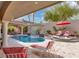 Spacious backyard includes a pool, lounging area, outdoor kitchen, and mature landscaping at 4108 Royal Scots Ave, Las Vegas, NV 89141