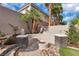 Inviting backyard with a built-in bench and cozy stone fire pit, perfect for outdoor gatherings at 4108 Royal Scots Ave, Las Vegas, NV 89141