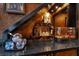 Basement wet bar area featuring elegant countertop, display shelves, and adjacent wine storage, enhancing the home's luxury at 4108 Royal Scots Ave, Las Vegas, NV 89141