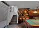 Basement showcasing a staircase with a wet bar area and pool table, blending leisure and design at 4108 Royal Scots Ave, Las Vegas, NV 89141