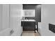 Modern bathroom featuring sleek vanity, illuminated mirror, and contemporary tile design, offering a spa-like experience at 4108 Royal Scots Ave, Las Vegas, NV 89141