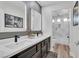 Modern bathroom features dual sinks, black faucets, lighted mirrors, and separate tub/shower at 4108 Royal Scots Ave, Las Vegas, NV 89141