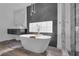 Chic bathroom featuring a soaking tub, modern vanity, and glass enclosed shower at 4108 Royal Scots Ave, Las Vegas, NV 89141