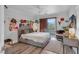 Bright bedroom with hardwood floors, a large window, and access to a balcony at 4108 Royal Scots Ave, Las Vegas, NV 89141