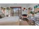 Comfortable bedroom featuring warm decor, hardwood flooring, and a cozy papasan chair at 4108 Royal Scots Ave, Las Vegas, NV 89141