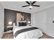 Cozy bedroom with modern ceiling fan, dark accent wall, and ample natural light, creating a relaxing atmosphere at 4108 Royal Scots Ave, Las Vegas, NV 89141