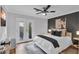 Comfortable bedroom with a ceiling fan, TV, and access to a private outdoor patio, perfect for relaxation at 4108 Royal Scots Ave, Las Vegas, NV 89141