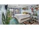 Charming bedroom with light blue walls, unique decor, and natural light from the shuttered window at 4108 Royal Scots Ave, Las Vegas, NV 89141