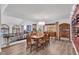 Open-concept dining room with hardwood floors, a large table, and views of the living area at 4108 Royal Scots Ave, Las Vegas, NV 89141