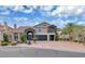 Stunning two-story home with stone accents, tile roof, and a well-manicured front yard with a brick driveway at 4108 Royal Scots Ave, Las Vegas, NV 89141
