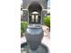 Close-up of the water feature and front entryway of the home with brick pathway and meticulously maintained landscaping at 4108 Royal Scots Ave, Las Vegas, NV 89141